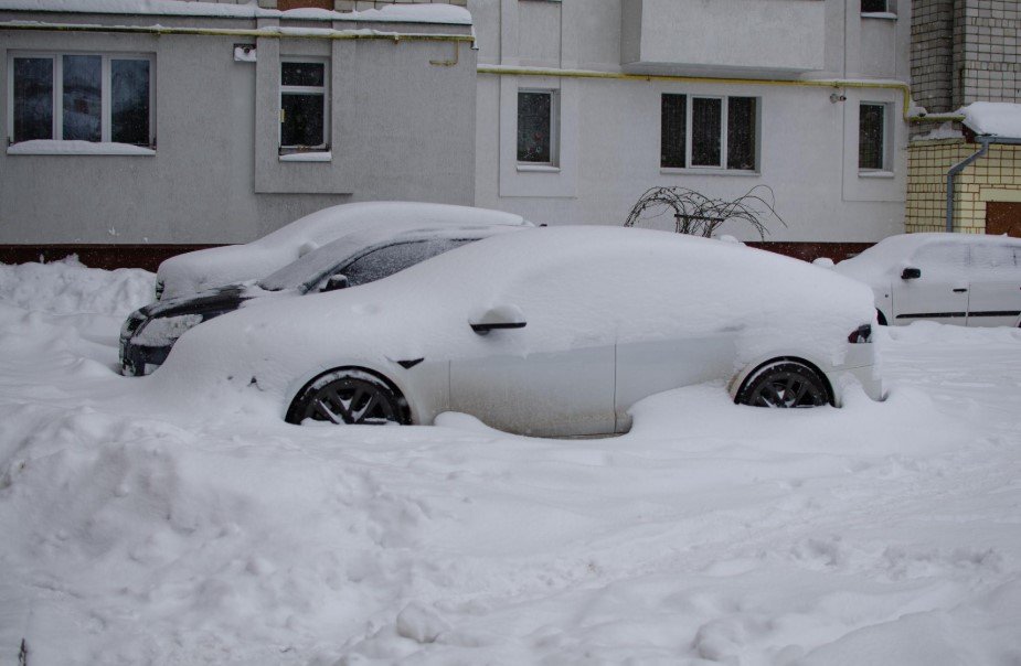 Snow-covered streets disappear under blowing snow as Midwest towns struggle through dangerous winter storm conditions.