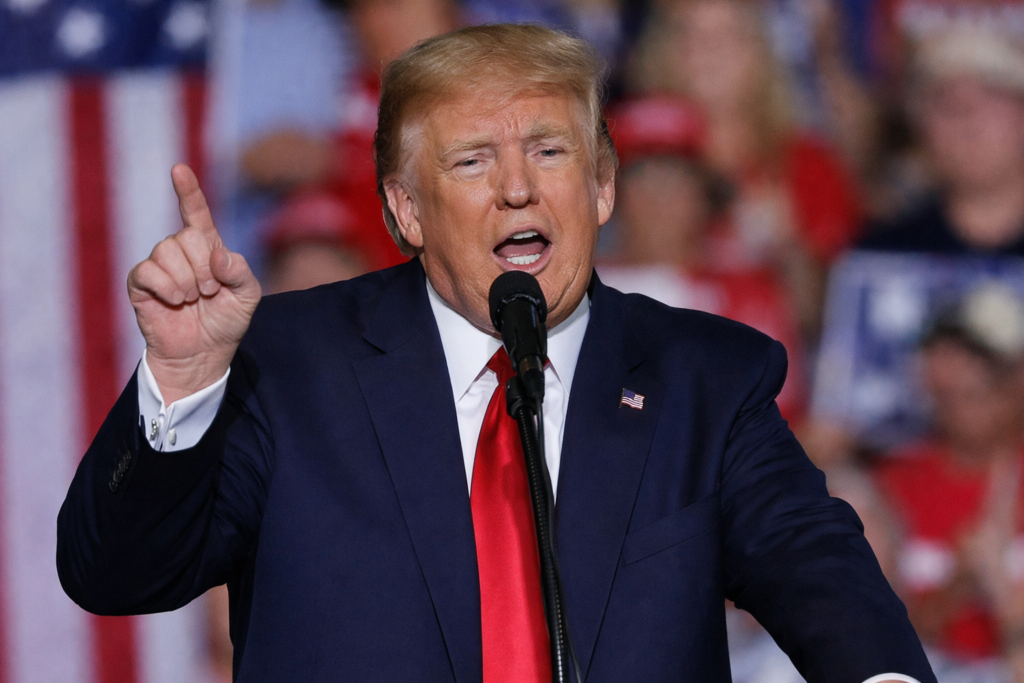 Donald Trump delivering a speech at a public rally while addressing U.S.–Israel political