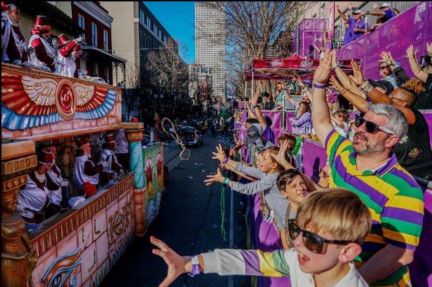 mardi gras beads on a balcony and carnival ornaments on a balcony in a street of the french quarter, new orleans, louisiana 2 mardi gras beads on a balcony and carnival ornaments on a balcony in a street of the french quarter, new orleans, louisiana 2