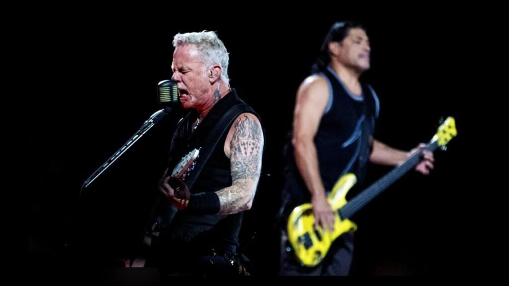 Metallica performing live during a high-energy concert with dramatic stage lighting and crowd atmosphere
