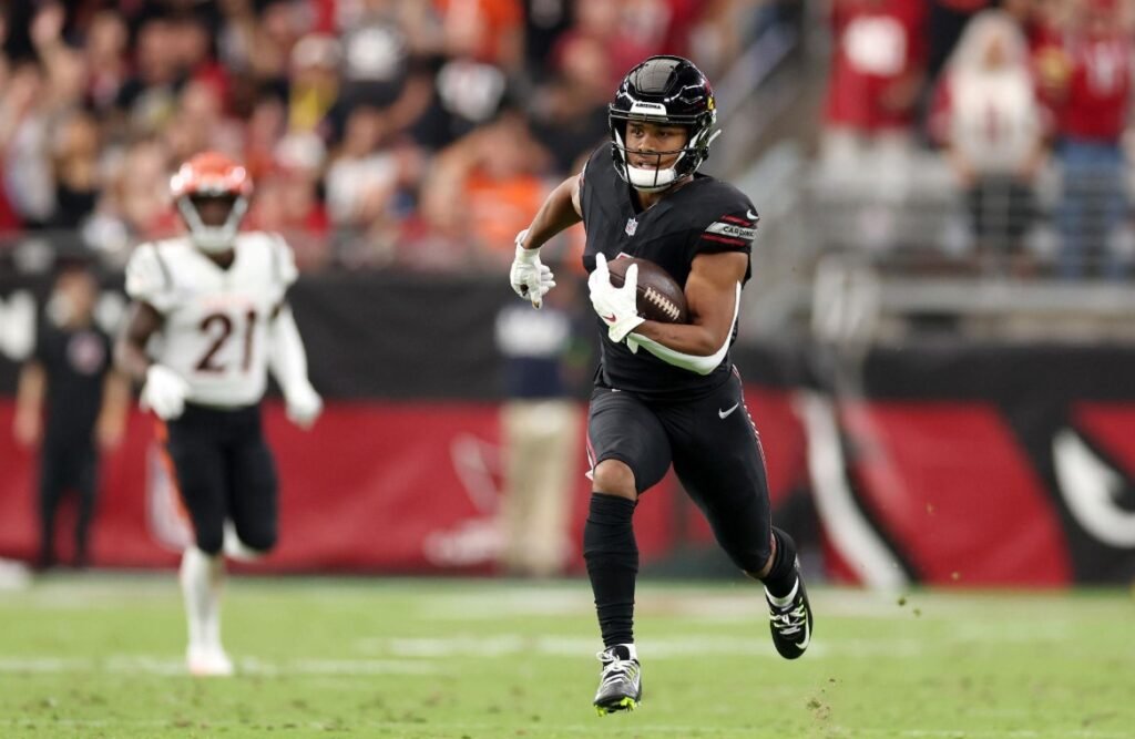 rondale moore running with the football during an nfl match showcasing explosive speed and athletic performance.